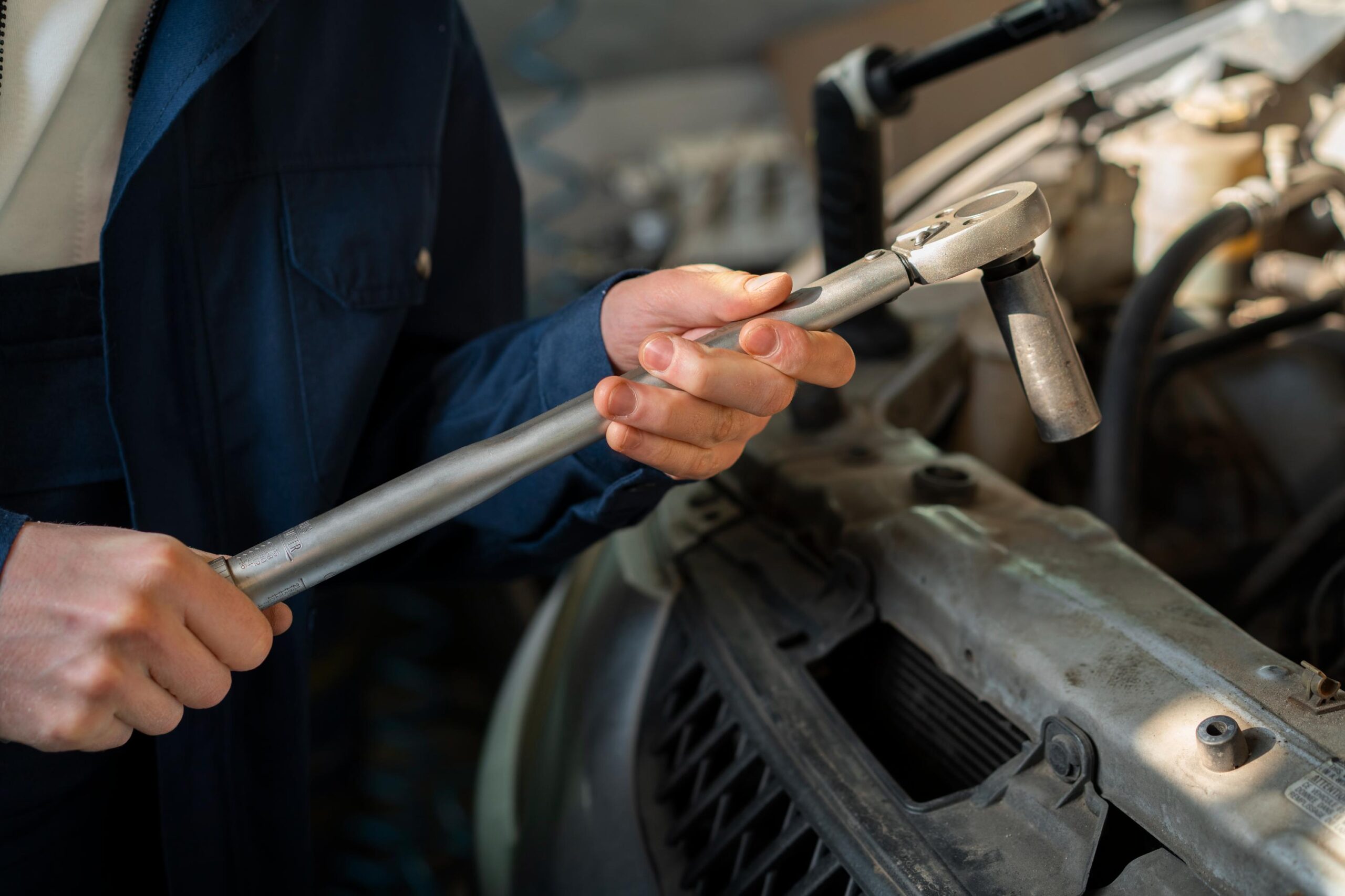 male-car-mechanic-working-car-repair-shop